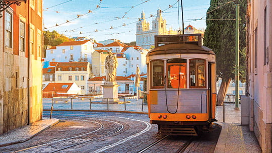 Lisbon's historic tramway travelling through the city streets, Portugal